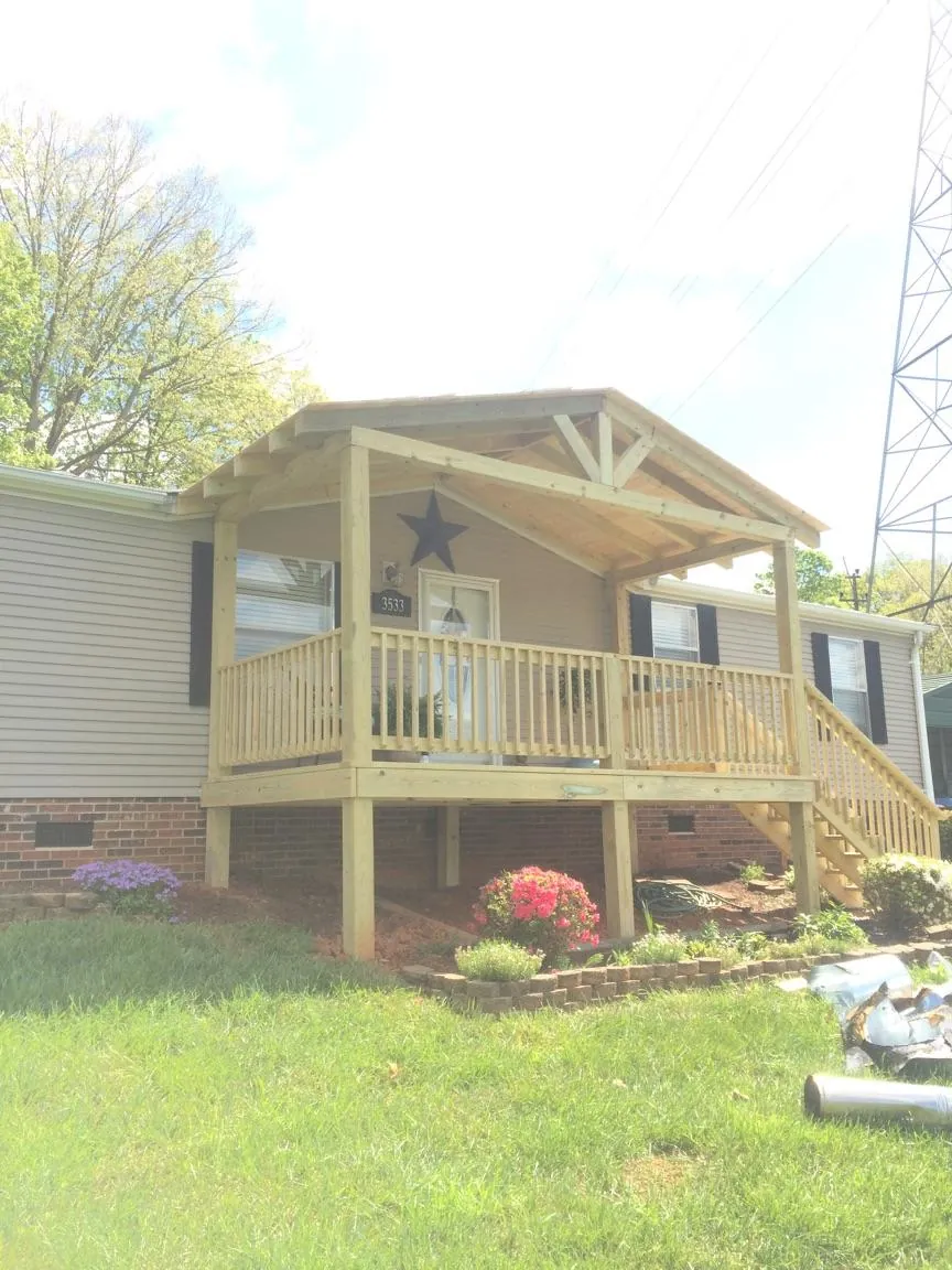 New gabled porch roof and deck railing added to a ranch home in Chesterville